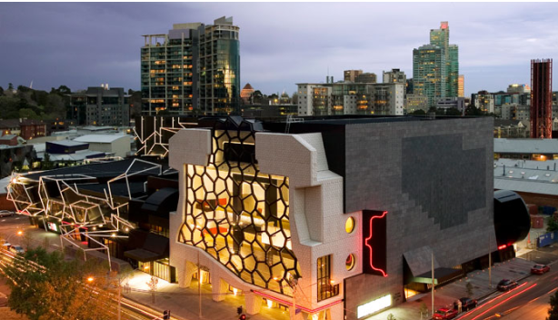 Exterior drone view of the Melbourne Recital Centre and skyline from the front at dusk